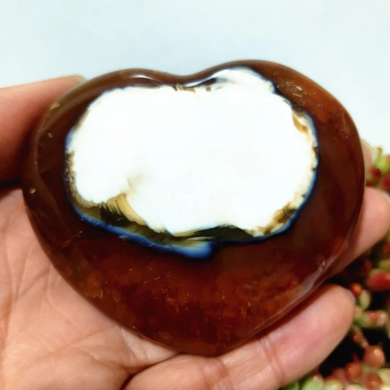 coeur-agate-inclusion-blanche-unique-naturelle-harmonie Cœur en agate naturelle avec large inclusion blanche, symbole de pureté et d'harmonie, tenu en main