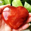 coeur-agate-rouge-naturelle-energie-positive-meditation Cœur en agate rouge naturelle, pierre énergisante pour la méditation et le bien-être, tenu en main avec des nuances vibrantes de rouge